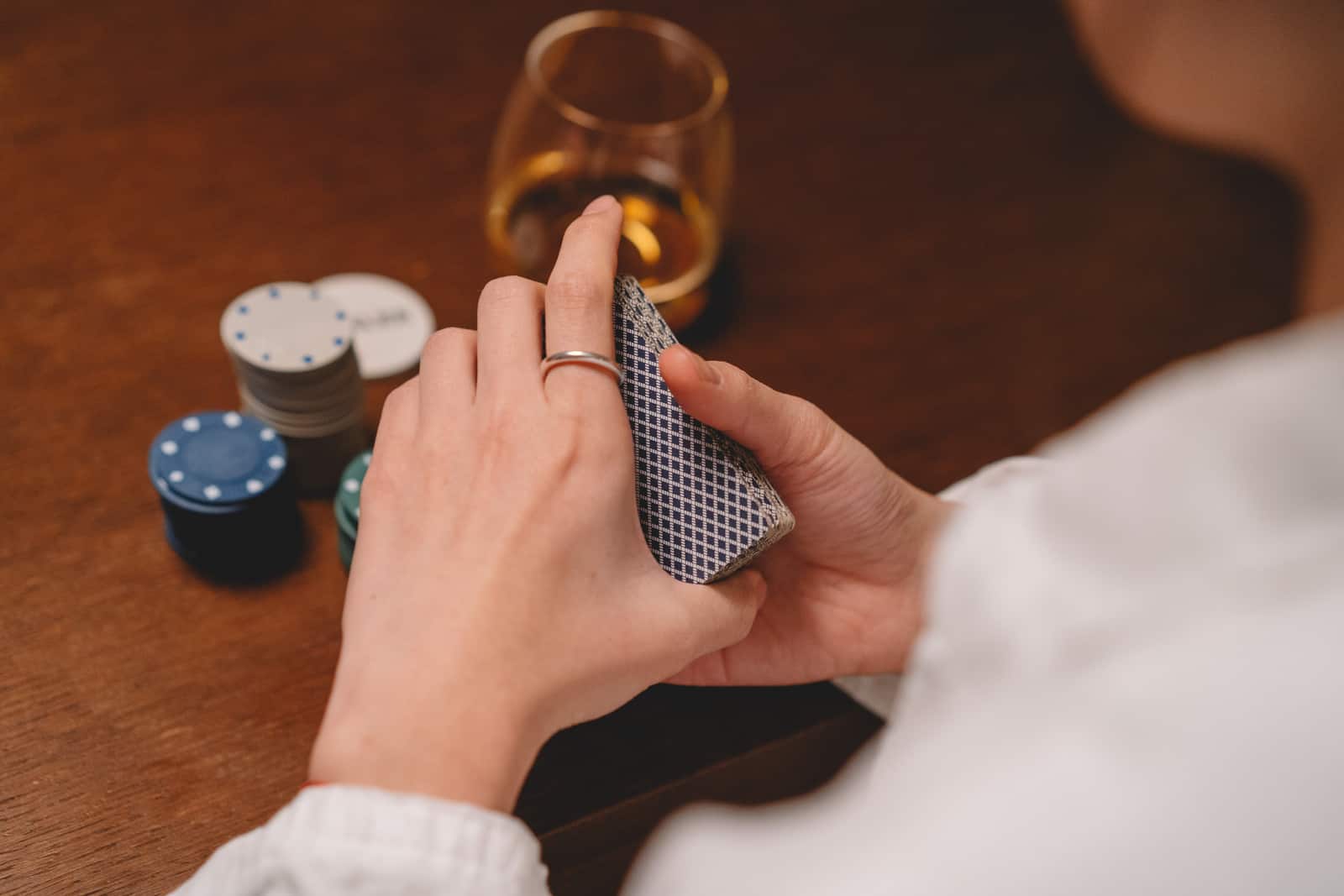 woman shuffles a deck of cards