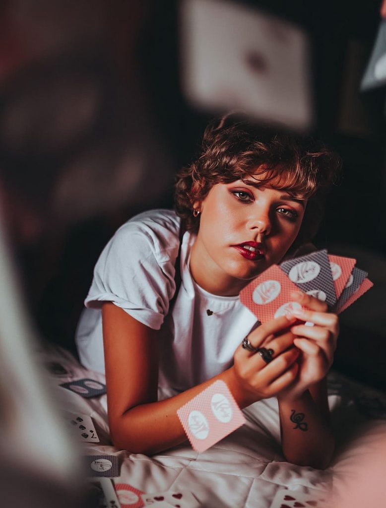 woman holding red and black cards