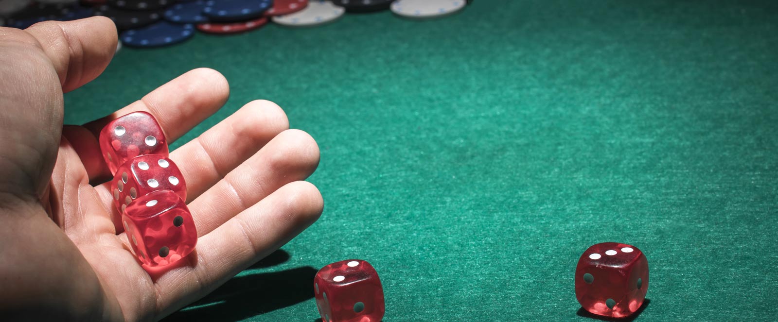 red dice in human hand